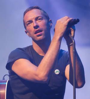 Chris Martin performs with Kings of Leon