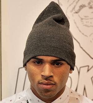Chris Brown urges fans to stop sending death threats to John Legend's partner