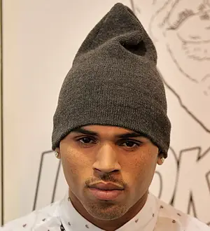 Chris Brown urges fans to stop sending death threats to John Legend's partner