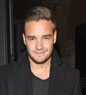 Liam Payne denies faking smile for fans
