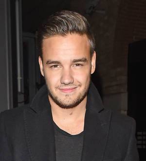 Liam Payne denies faking smile for fans