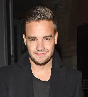 Liam Payne denies faking smile for fans
