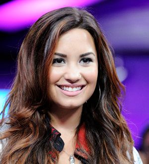Lovato marks rehab anniversary with big baseball gig