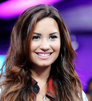 Lovato marks rehab anniversary with big baseball gig