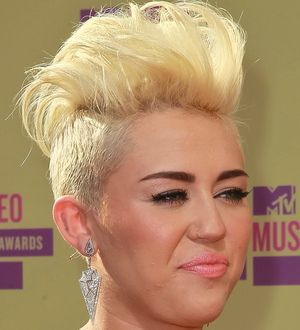 Miley Cyrus is all grown-up in cake fight video