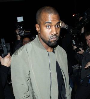 Kanye West in and out of jail for booking over paparazzo attack