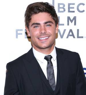 Zac Efron all smiles with football team after jaw injury