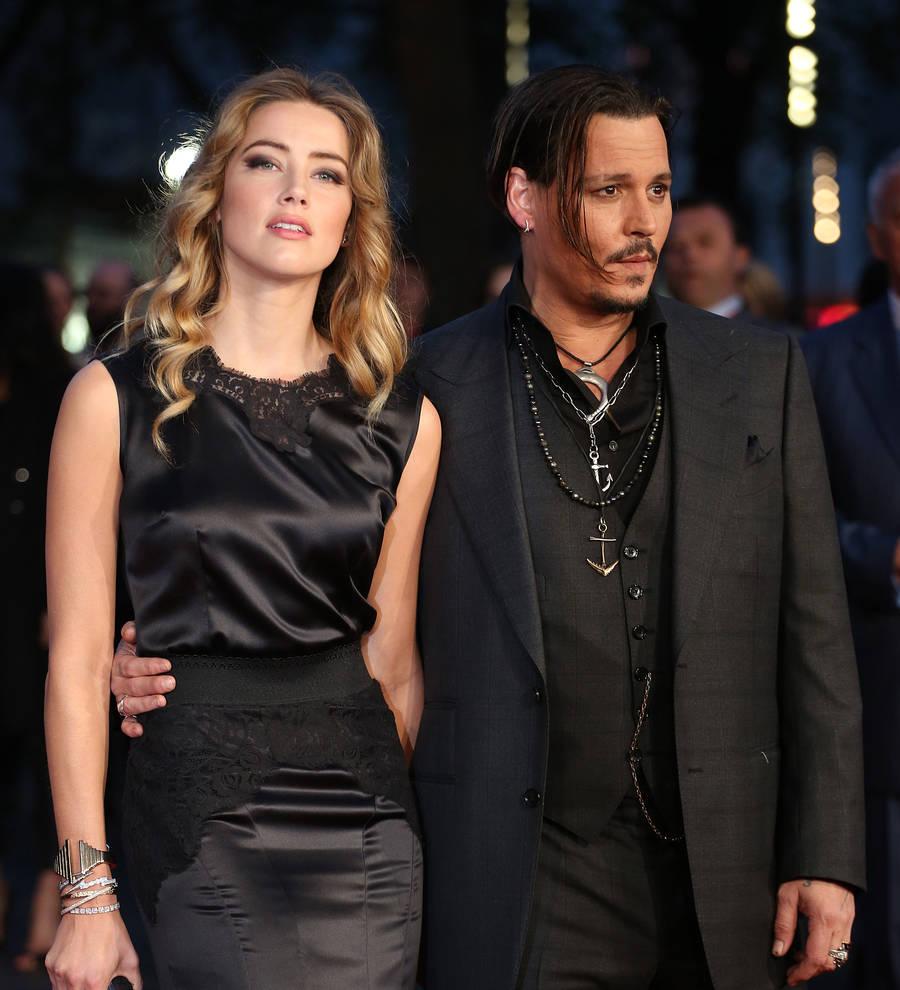 Amber Heard's lawyer wins postponement in dog case